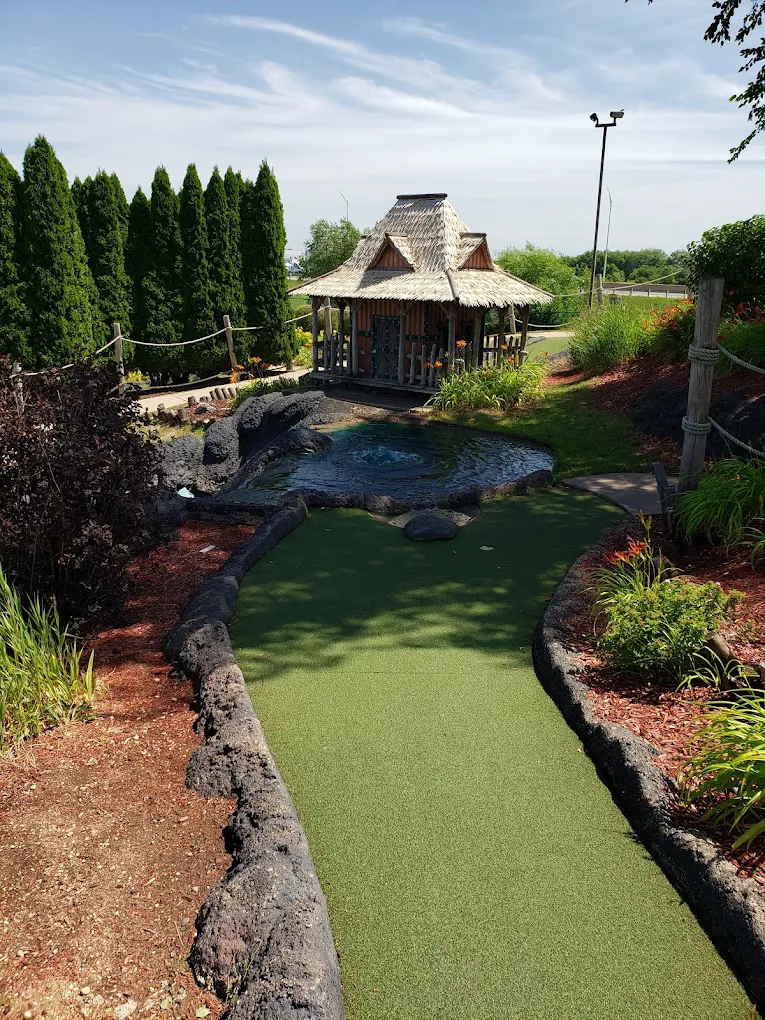Tiki hut hole with tropical pond